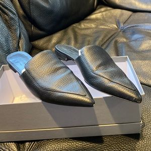 Everlane black faux leather slides.